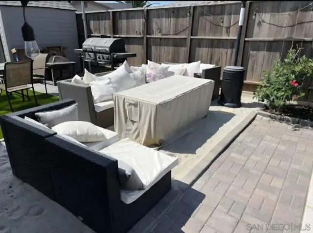 a living room with a couch and potted plants
