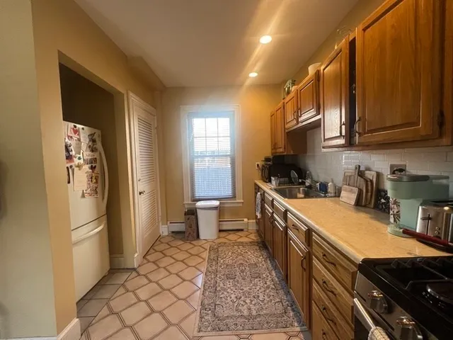 a kitchen with a refrigerator and a sink
