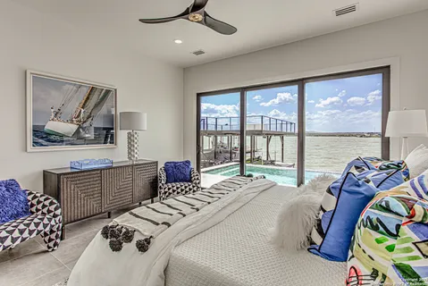 a bedroom with furniture and a large window