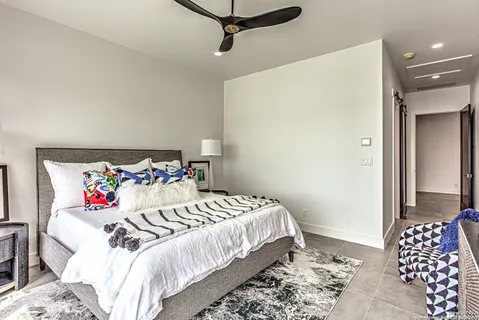 a bedroom with a bed and a chandelier