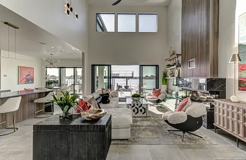 a living room with fireplace furniture and a potted plant