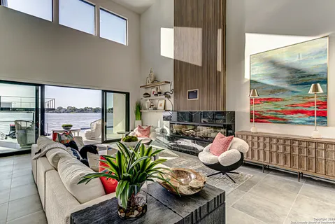 a living room with furniture and a floor to ceiling window
