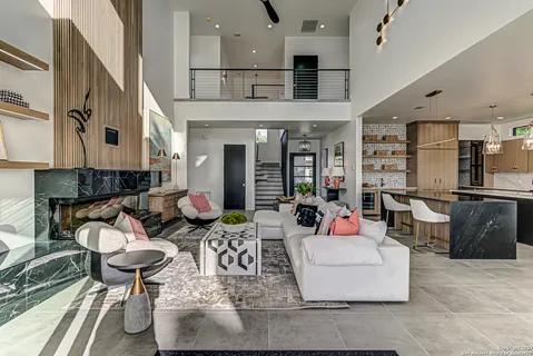 a living room with furniture and kitchen view