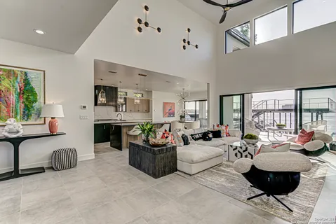 a living room with fireplace furniture and a large window