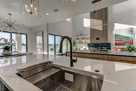 a kitchen with stainless steel appliances granite countertop a sink and cabinets