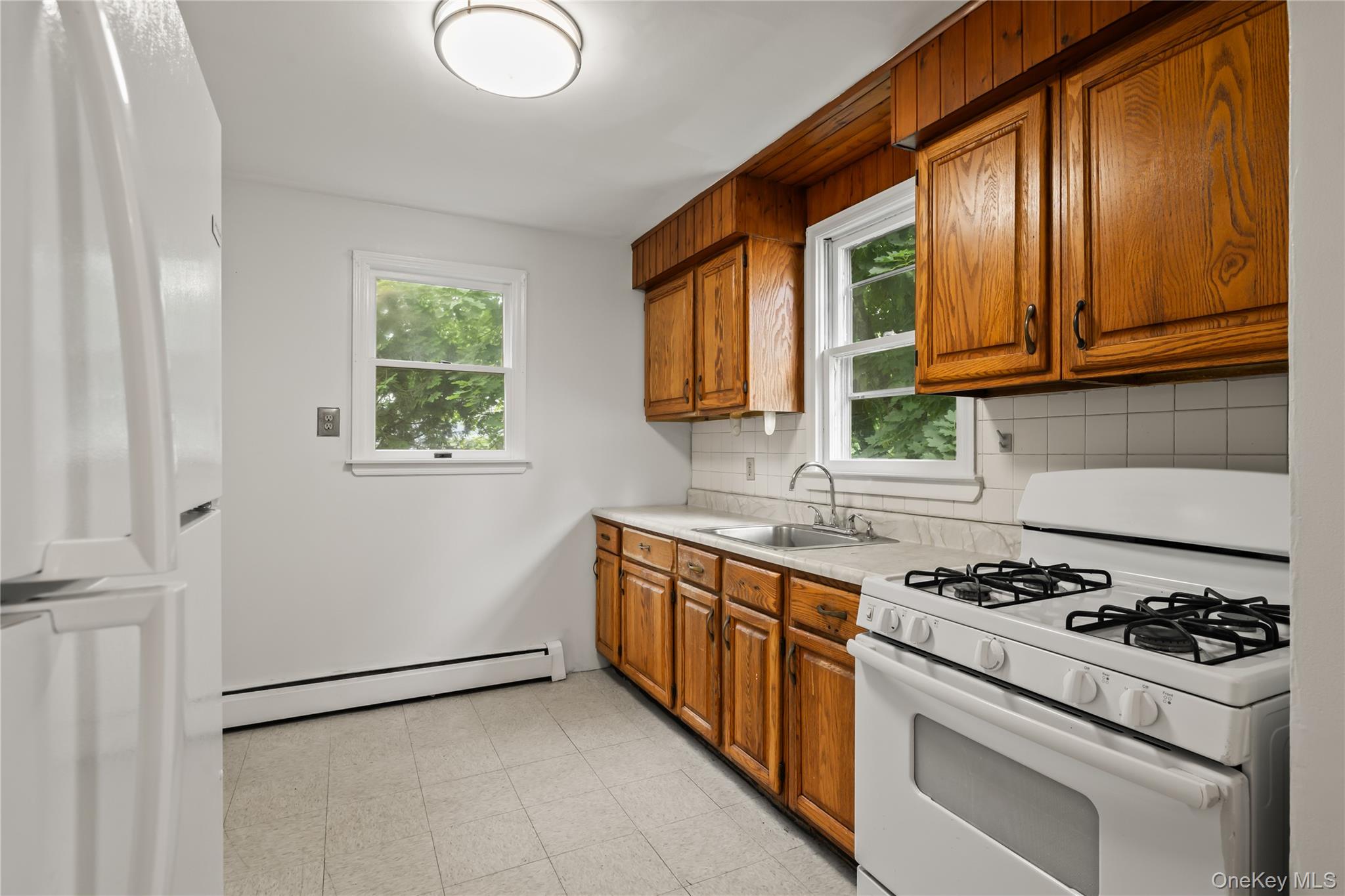 281-283 Old Haverstraw Road Congers, NY 10920 - Photo 11 of 41 a kitchen with stainless steel appliances granite countertop a stove a sink and a refrigerator