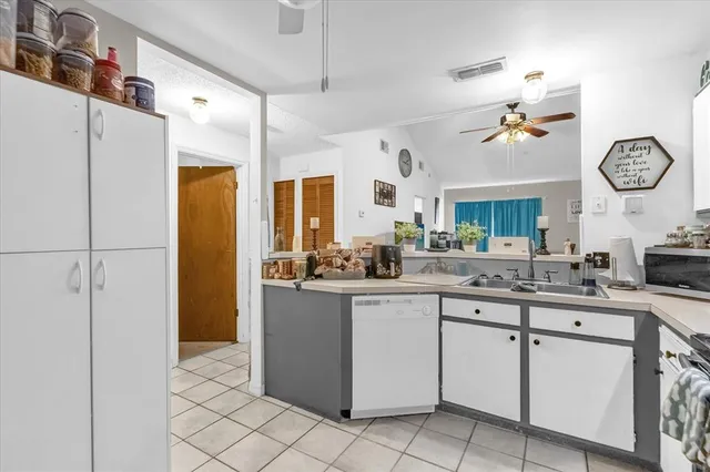 a kitchen with cabinets a sink and appliances