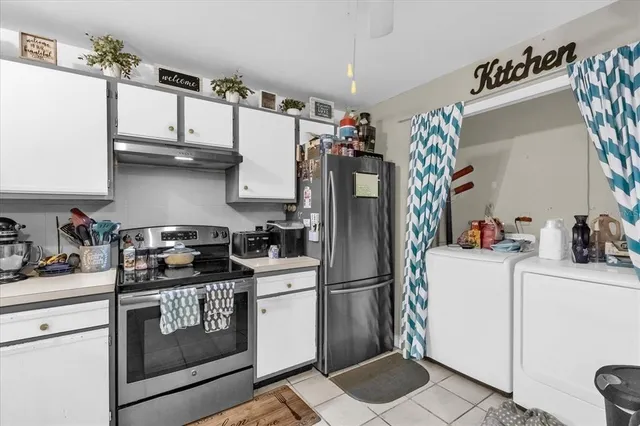 a kitchen with stainless steel appliances granite countertop a refrigerator sink and stove