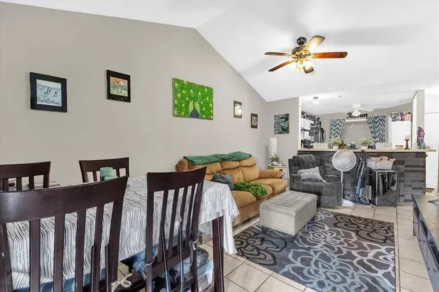 a living room with lots of furniture and view of kitchen