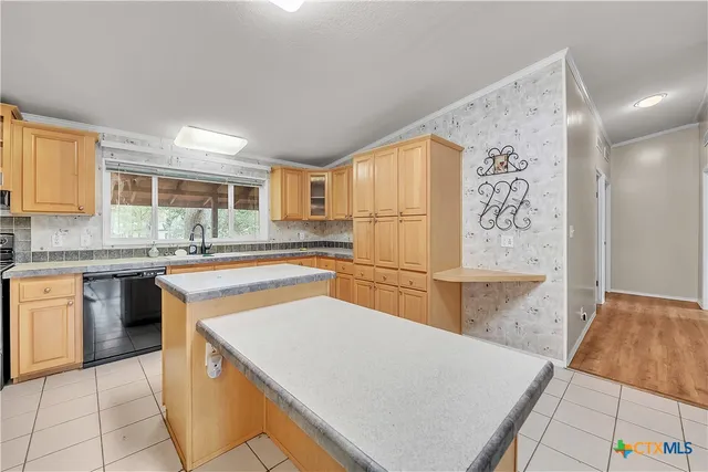 a kitchen that has a sink and a stove in it