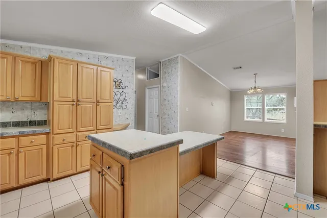 a kitchen with stainless steel appliances a refrigerator sink and cabinets