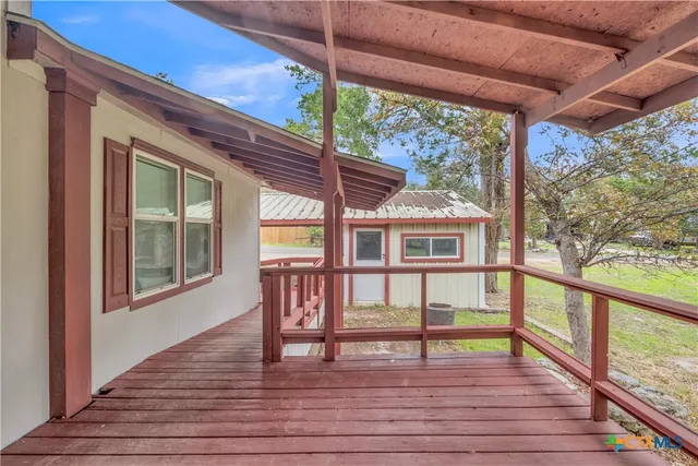 a view of a kitchen with a sink and a refrigerator
