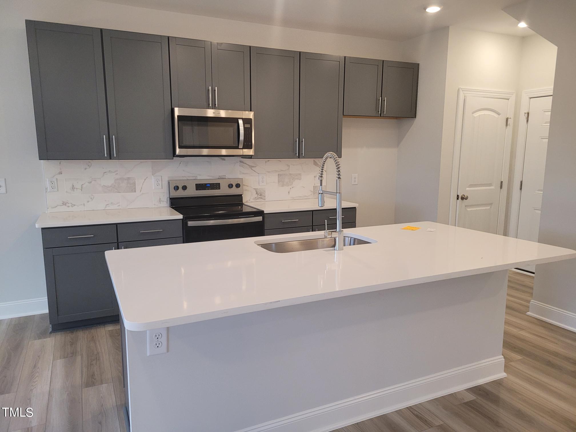 3611 Tarmac Road West Wilson, NC 27896 - Photo 12 of 28 a kitchen with a sink a microwave and cabinets
