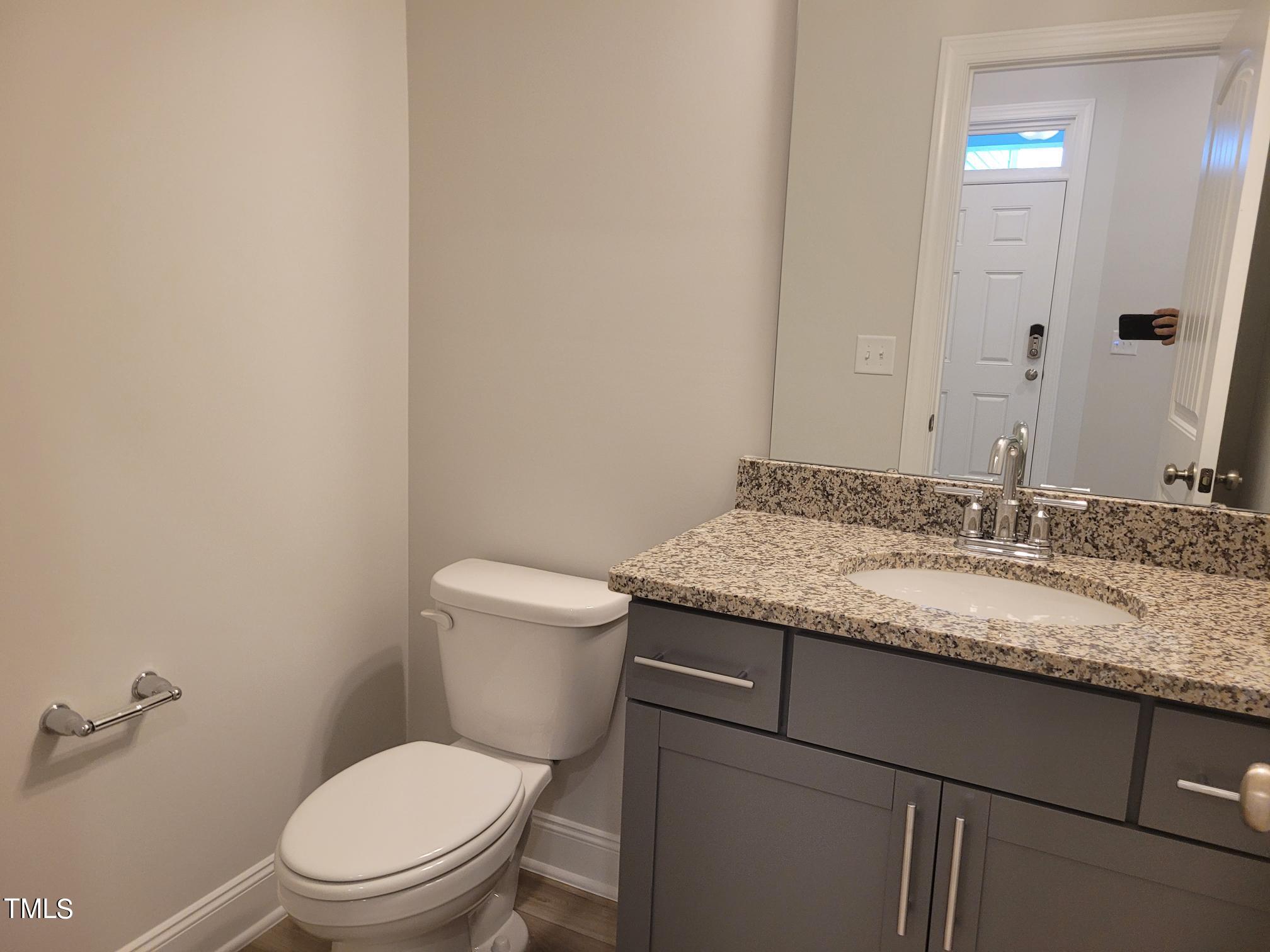 3611 Tarmac Road West Wilson, NC 27896 - Photo 16 of 28 a bathroom with a granite countertop toilet and a sink