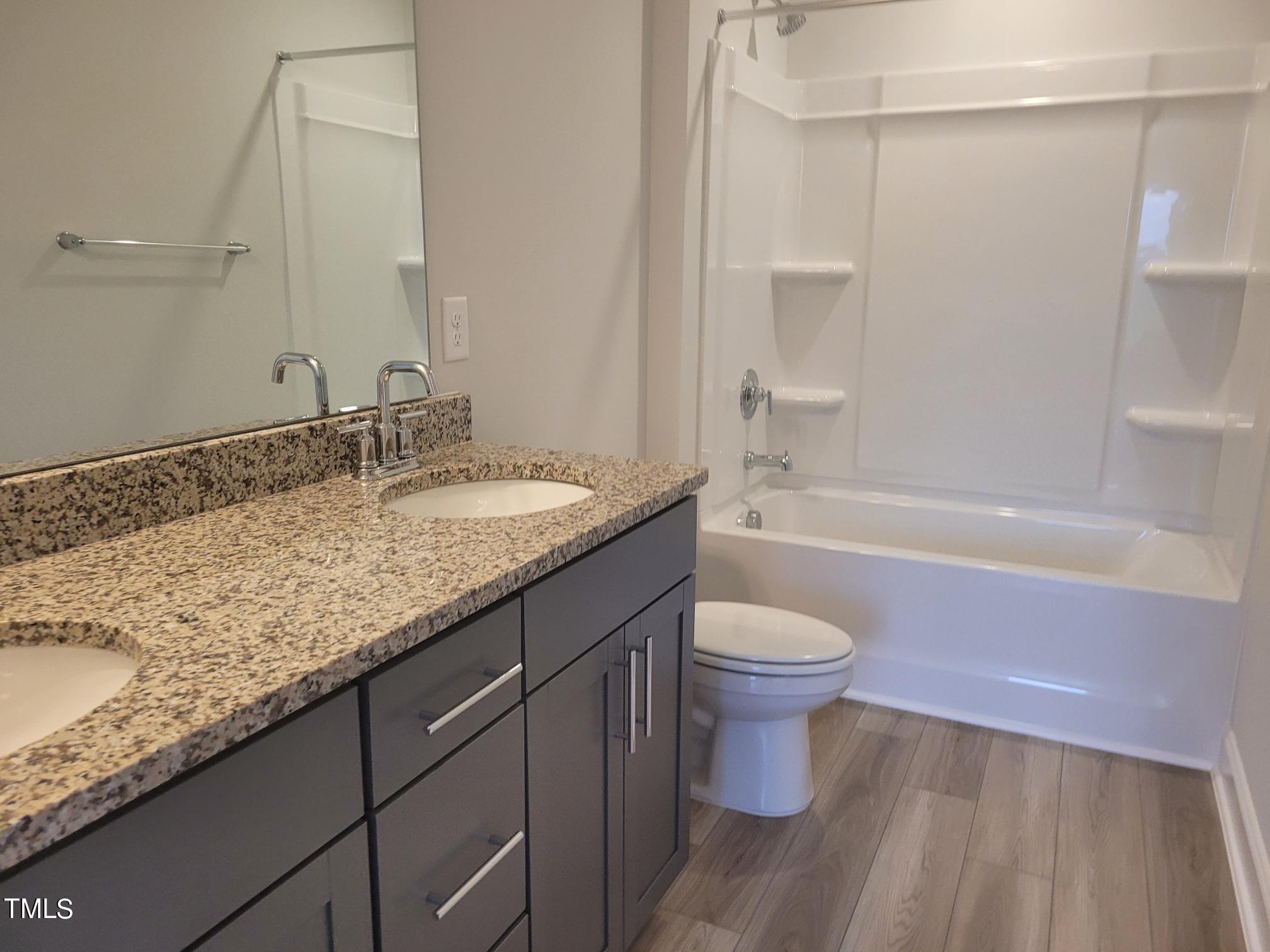 3611 Tarmac Road West Wilson, NC 27896 - Photo 19 of 28 a bathroom with a granite countertop sink toilet and shower