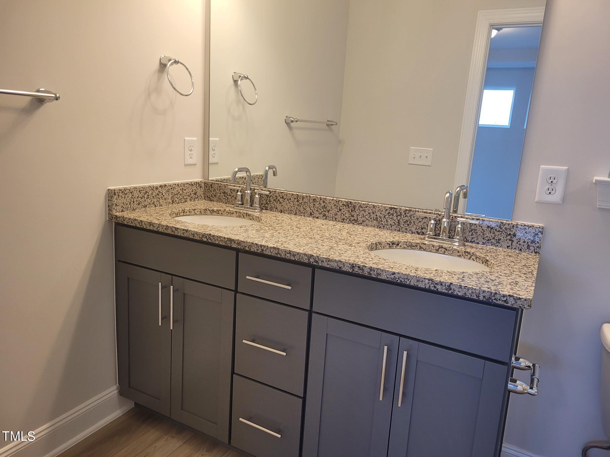 3611 Tarmac Road West Wilson, NC 27896 - Photo 24 of 28 a bathroom with a granite countertop sink and a mirror