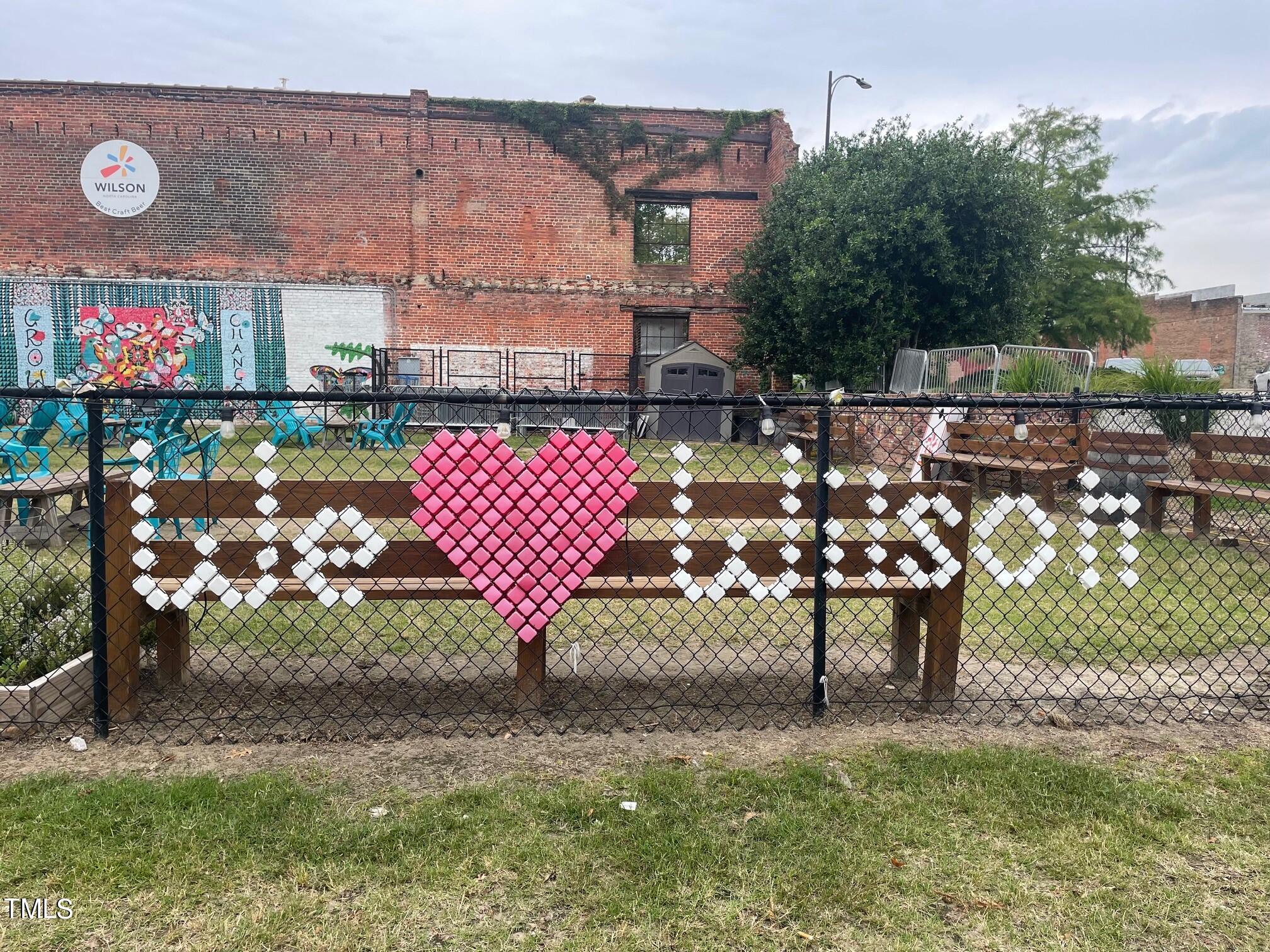 3611 Tarmac Road West Wilson, NC 27896 - Photo 5 of 28 a wooden bench sitting in front of a building