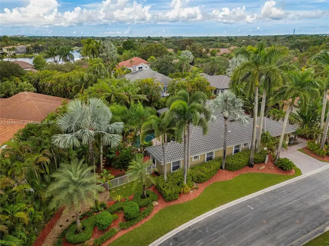 a front view of a house with lots of flowers