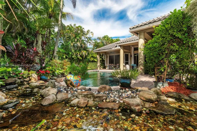 a view of a dining room with furniture and a chandelier