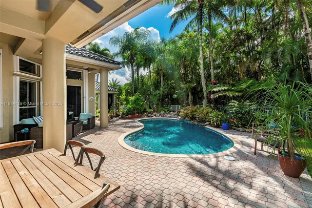 a living room with furniture a rug and a chandelier