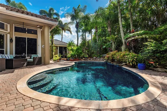 a kitchen with stainless steel appliances granite countertop a stove sink and microwave