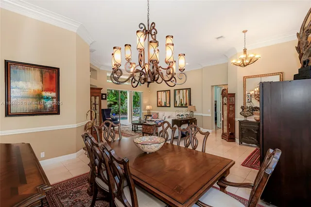 a view of a dining room with furniture a chandelier and wooden floor