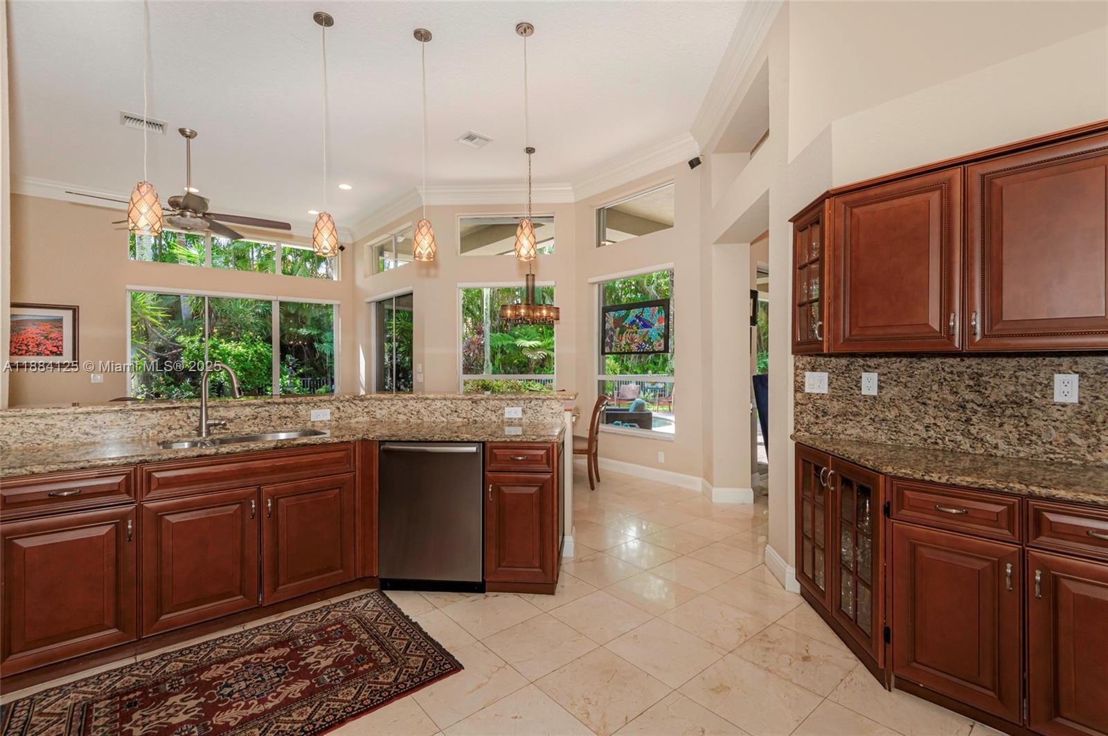 1100 Southwest 156th Avenue Pembroke Pines, FL 33027 - Photo 28 of 86 a kitchen with stainless steel appliances granite countertop wooden cabinets and a stove