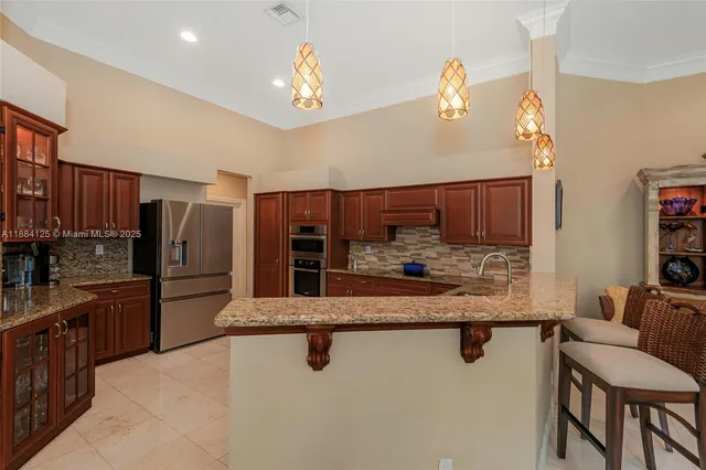 a bathroom with a granite countertop sink a toilet a shower and a mirror