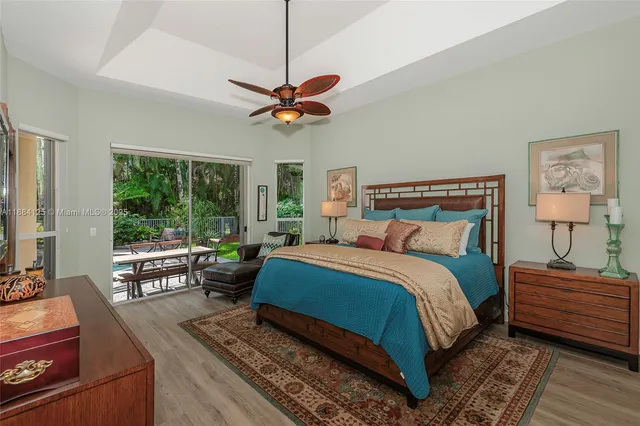 a front view of a house with a garden and lake view