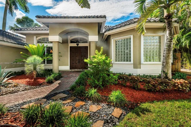 a view of a house with a backyard patio and swimming pool