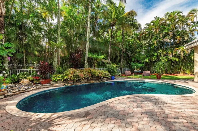 a view of a dining room with furniture a chandelier and wooden floor