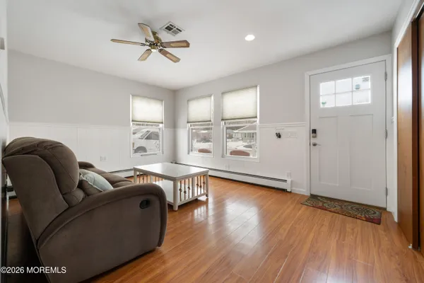 a living room with furniture a rug and a flat screen tv