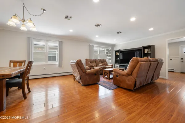 a view of a dining room with furniture and wooden floor