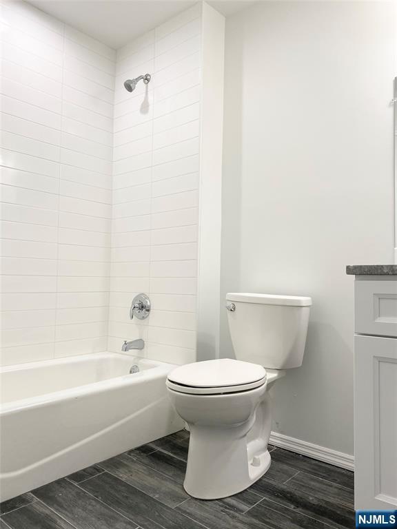 61 Chestnut Street, Unit 2 Lodi, NJ 07644 - Photo 12 of 22 a bathroom with a white toilet and bathtub