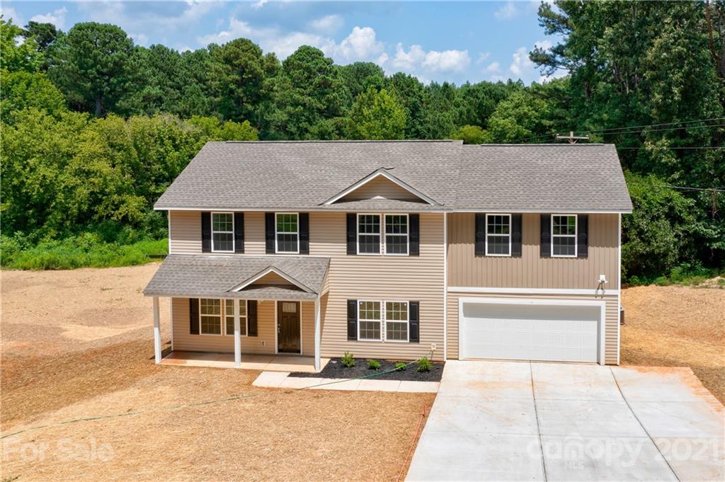 1720 Love Road Monroe, NC 28110 - Photo 40 of 48 a front view of a house with a garden