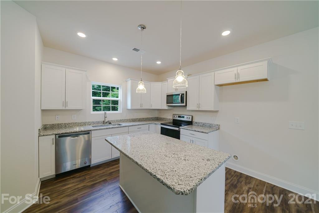 1720 Love Road Monroe, NC 28110 - Photo 8 of 48 a kitchen with stainless steel appliances granite countertop a sink stove and cabinets