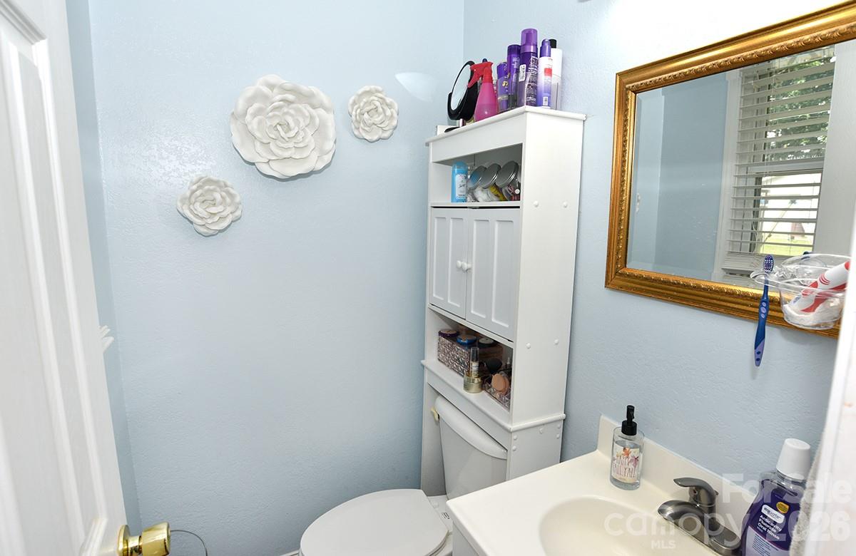 130 Happy Hollow Road, Unit 13/B Rockwell, NC 28138 - Photo 11 of 17 a bathroom with a toilet a sink and a mirror