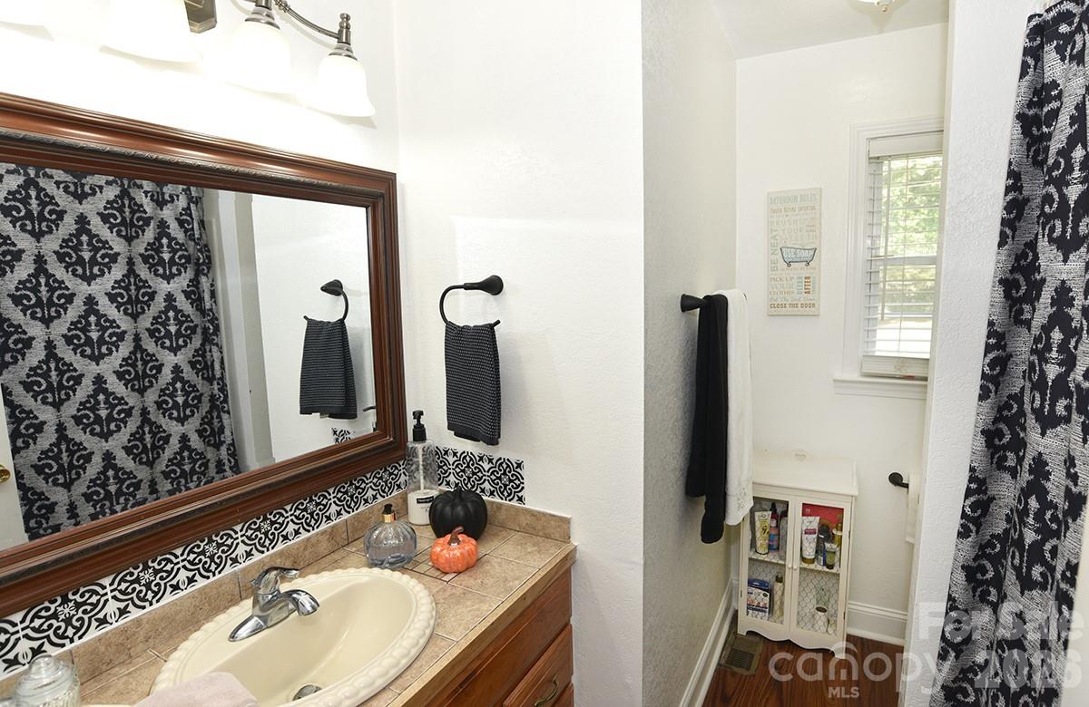 130 Happy Hollow Road, Unit 13/B Rockwell, NC 28138 - Photo 12 of 17 a bathroom with a sink and a mirror
