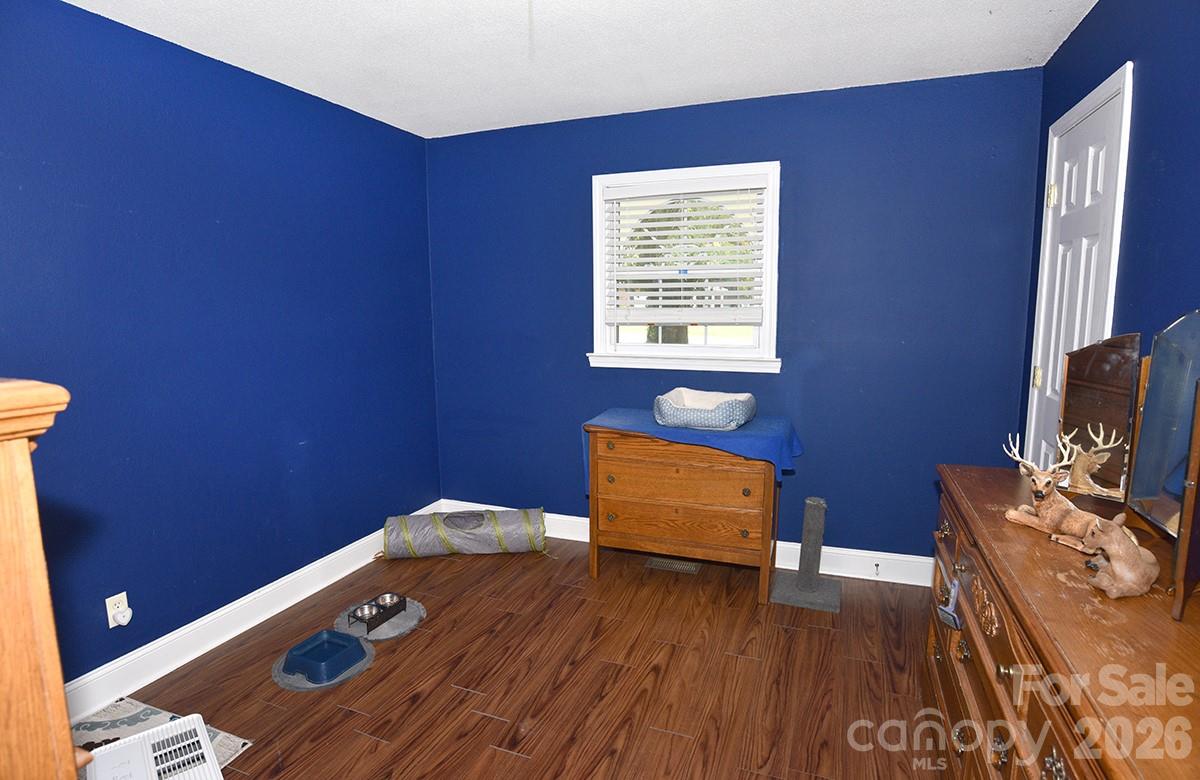 130 Happy Hollow Road, Unit 13/B Rockwell, NC 28138 - Photo 14 of 17 a room with furniture and wooden floor