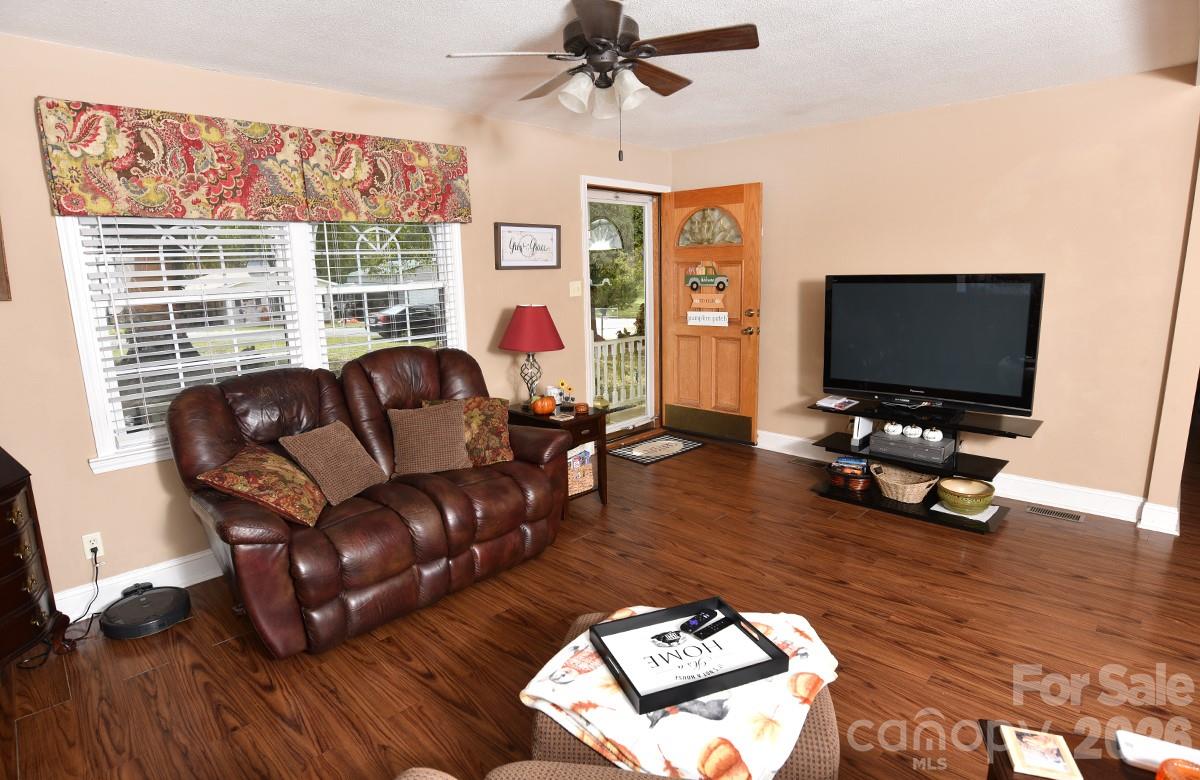 130 Happy Hollow Road, Unit 13/B Rockwell, NC 28138 - Photo 8 of 17 a living room with furniture and a flat screen tv