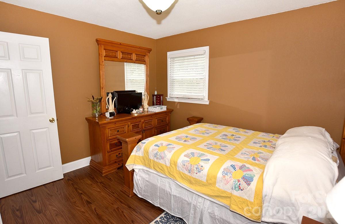 130 Happy Hollow Road, Unit 13/B Rockwell, NC 28138 - Photo 9 of 17 a bedroom with a bed and wooden floor