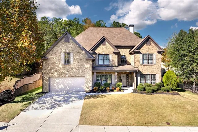 a view of a white house with a yard and plants