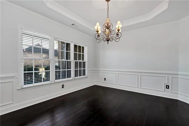 an empty room with wooden floor and fireplace