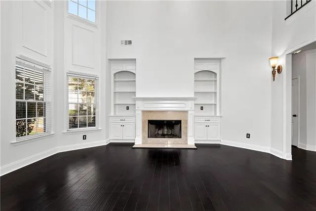 a bathroom with a granite countertop sink a toilet and a mirror