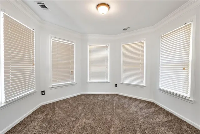 a view of a hallway with wooden floor and stairs
