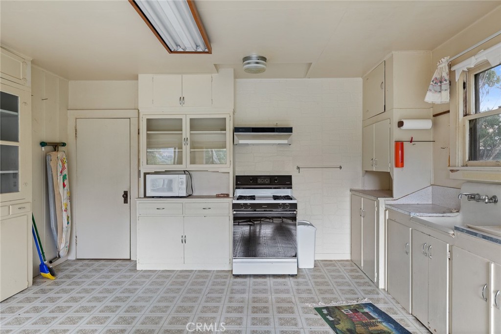 2645 Adobe Road Morro Bay, CA 93442 - Photo 6 of 28 a kitchen with stainless steel appliances kitchen island granite countertop a refrigerator and a stove