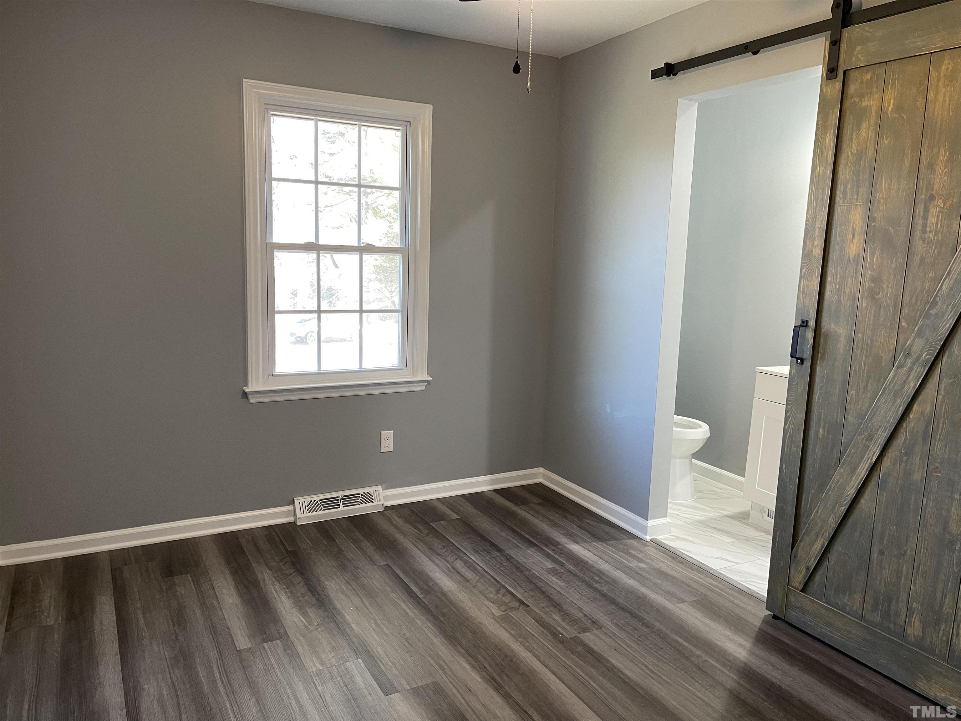 5425 Louisburg Road Raleigh, NC 27616 - Photo 10 of 15 a view of a room with wooden floor and small window