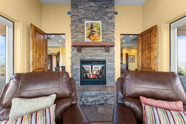 a living room with furniture and a floor to ceiling window