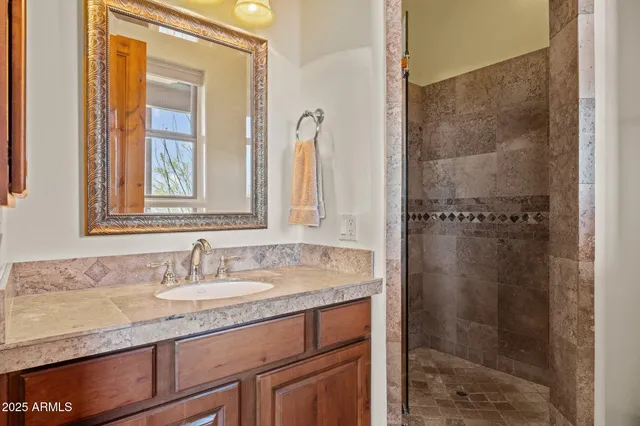 a kitchen with granite countertop a sink stove and cabinets