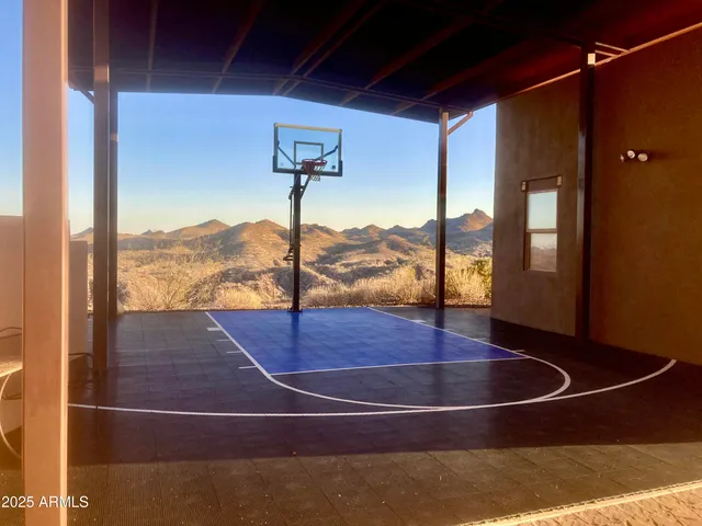 a view of a large building with mountains in the background